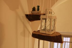 a lantern sitting on a wooden shelf with a plant at Sesta Strada in Civitavecchia