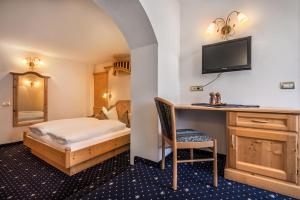 Posteľ alebo postele v izbe v ubytovaní Hotel Ciasa Tamá