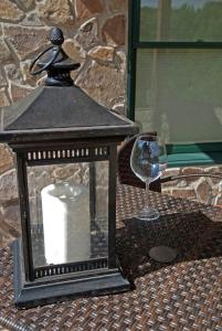 a lantern and a wine glass on a table at Shirley's Bed And Breakfast in Roanoke