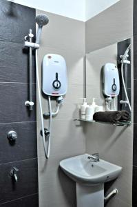 a bathroom with a toilet and a sink and a mirror at Tanjong Inn in Kota Bharu