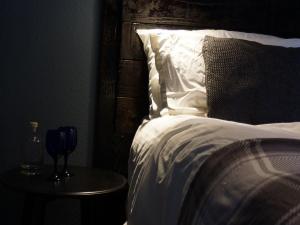 a bedroom with a bed and a table with a wine glass at Skyline Guesthouse in Newquay