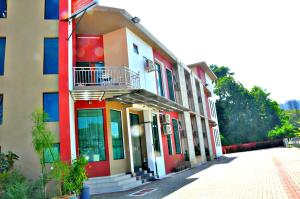 a building with a balcony on the side of it at Tanjong Inn in Kota Bharu