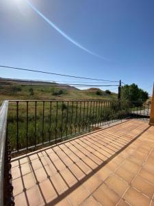 a black fence with a view of a field at Hotel Hostería de Monzón in Monzón de Campos