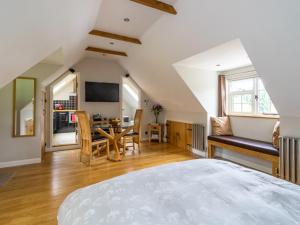 a bedroom with a bed and a dining room at Souters Cottage Annexe in Chichester