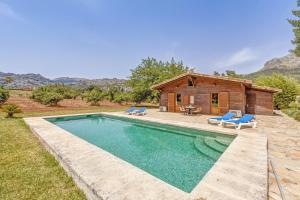 a house with a swimming pool and a cabin at Finca L'hort Nou in Pollença