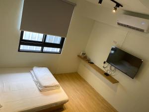 TV i/ili multimedijalni sistem u objektu Donghai Cottage Backpack Inn Suite