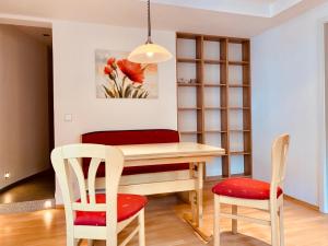 a dining room with a table and two chairs at Modernes Apartment am Bodensee in Wasserburg