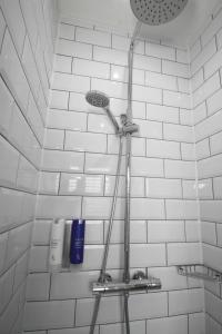 a shower in a bathroom with white tiles at Stay at No. 2 in Taunton