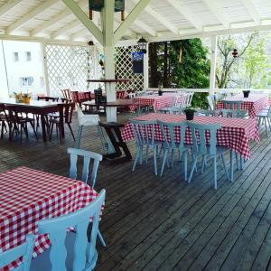 a restaurant with red and white tables and chairs at Landgasthof Fischer in Lichtenfels