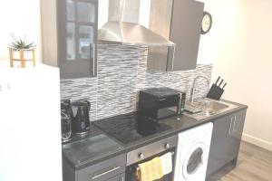 a kitchen with a sink and a microwave at NEW APARTMENT - Offline Bookings on 079-504-13594 in Bradford