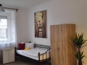 a small bedroom with a bed and a window at Sultania's Melanchthon in Nuremberg