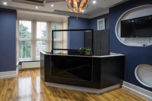 a living room with a large black entertainment center at High Bank Hotel in Leeds