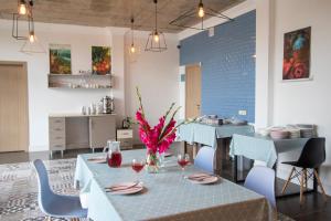 a dining room with a table with glasses of wine at Terassa Hotel Kobuleti in Kobuleti