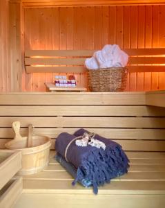 a sauna with a blanket and a basket on a shelf at Romantic Wellness BnB Noordwijk in Noordwijk aan Zee +39 photos