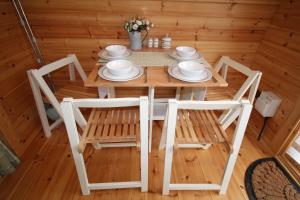 a wooden table and chairs in a room at Glamping Huts in Heart of Snowdonia in Dolgellau