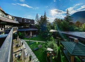 an aerial view of a house with a patio and a garden at Poiana Brasov Alpin Resort Apartment in Poiana Brasov