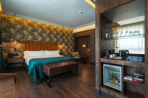 a hotel room with a bed and a fireplace at Catalonia Donosti in Donostia-San Sebastián
