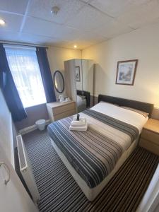 a bedroom with a large bed with a tray on it at Grange House Hotel in Blackpool