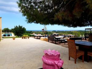 a pink fire hydrant sitting in the middle of a patio at Terre Di Vendicari in Noto