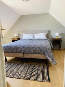 a bedroom with a large bed with two night stands at LE DOMAINE DE COAT ROGAN L'espace familial in Ploëzal
