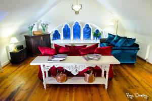 a living room with a couch with red and blue pillows at Boys Dormitory in Fort Augustus