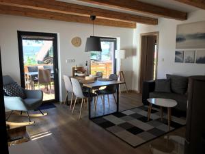 a living room with a table and a couch at Chata Bellis in Černá v Pošumaví