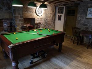 a pool table with balls on it in a room at The Commercial Hotel in Tarland