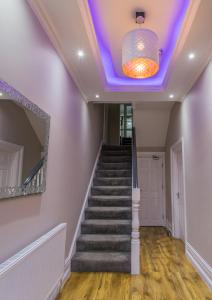 a staircase with a purple ceiling and a mirror at High Bank Hotel in Leeds