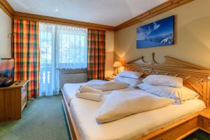 Postelja oz. postelje v sobi nastanitve SCOL Sporthotel Zillertal