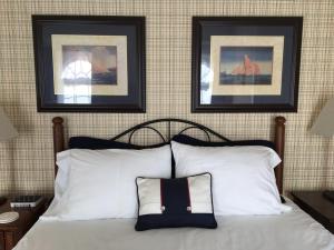 a bedroom with a bed with two pictures on the wall at The Doctor's Inn in Oxford