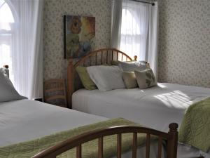 a bedroom with two beds and a window at The Doctor's Inn in Oxford