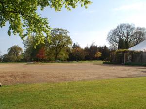 a large open field with trees in the background at Park Hill Hotel in Lowestoft