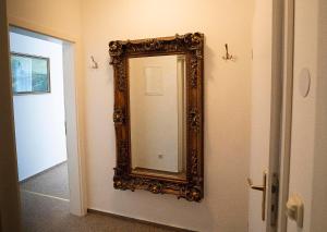 a mirror hanging on a wall next to a door at Pension am Dom in Schwerin