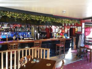 a bar with a lot of bottles on the wall at The Harnser in Stalham