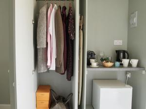 a closet filled with lots of clothes at The Pig Shed Motel in Castle Acre