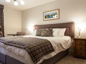 a bedroom with a large bed with a wooden headboard at Parkers House Bed & Breakfast in Newtown