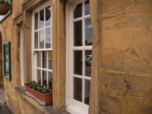 a window with flowers in a pot on a building at Phelips Arms in Yeovil