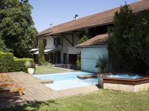 a swimming pool in front of a house at Le Domaine du Plantier in Saint-Hilaire-de-la-Côte