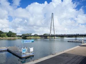 a boat on the water with a bridge in the background at The Heidi Bed & Breakfast in Southport