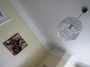 a chandelier hanging from a ceiling in a room at The Heidi Bed & Breakfast in Southport