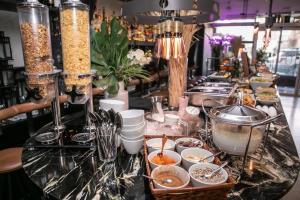 a buffet line with dishes of food on a counter at Ultra Tel Aviv Boutique Hotel in Tel Aviv