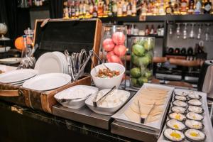 a buffet with plates and bowls of food on a counter at Ultra Tel Aviv Boutique Hotel in Tel Aviv