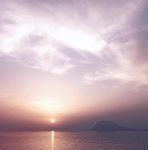 a sunset over the ocean with a cloudy sky at Sealoft in Patra