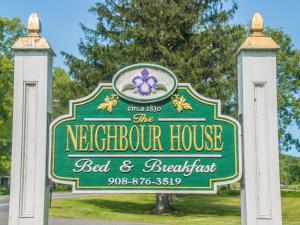 a sign for the waterfront house bed and breakfast at The Neighbour House B&B in Long Valley
