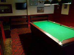 a pool table in a pub with a green at The Railway Inn in Dawlish
