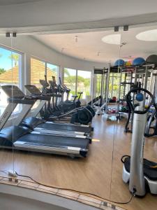 a gym with rows of treadmills and elliptical machines at Beautiful apartment for rent in Quinta do Lago with excellent resort facilities close to lake and beach. in Quinta do Lago