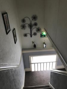 a stairway with a stair case with a palm tree on the wall at Westbourne House in Blackpool