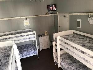 a bedroom with two bunk beds and a dresser at Westbourne House in Blackpool