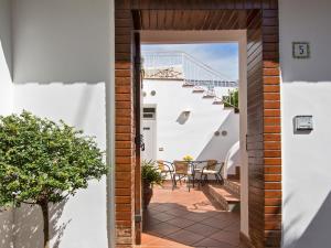 an open door to a patio with a table and stairs at San Nicola Guest House in Anacapri