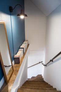 a stairway with a bunch of books on it at Gite la Maison du Tonnelier in Comblanchien +30 photos